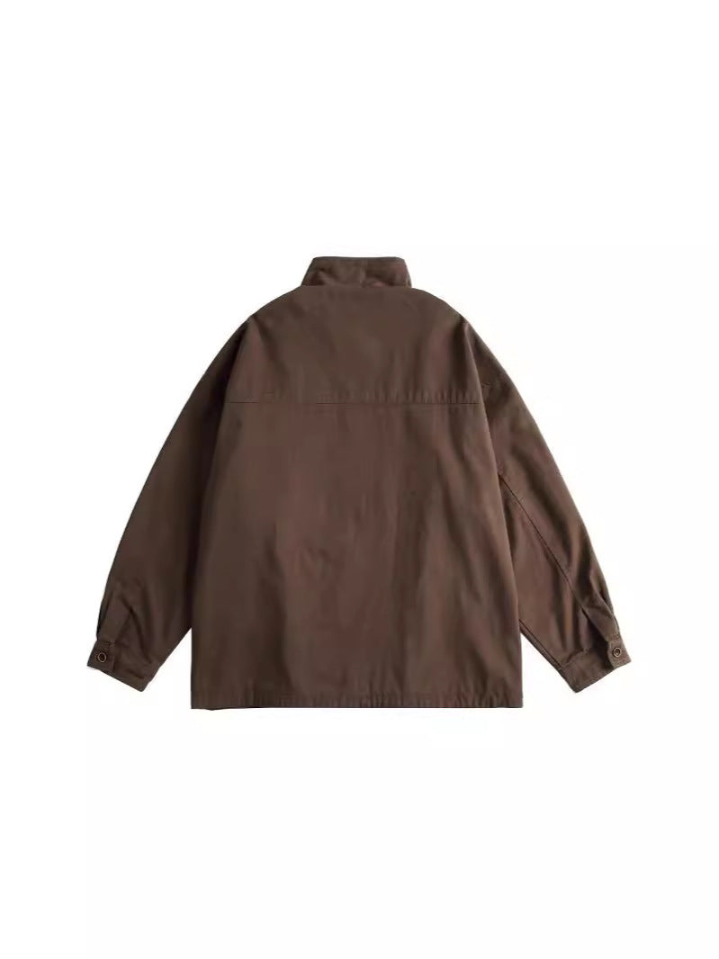 Hagane utility jacket in brown, back view showing the yoke seam, dropped shoulder and buttoned cuffs