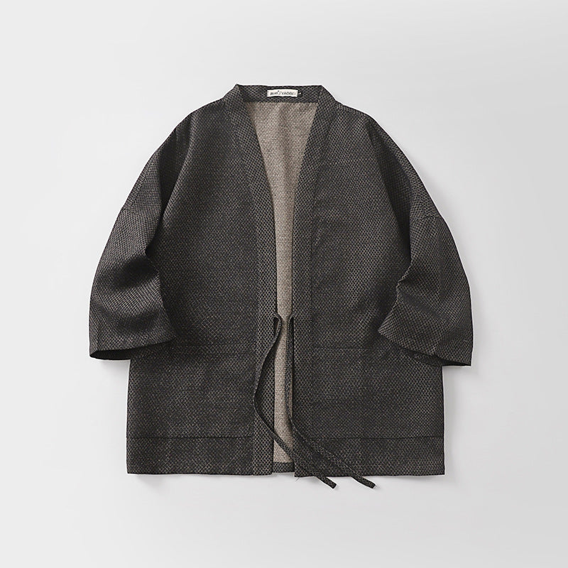 Karo haori jacket laid flat, showing the open front, waist tie, two hip patch pockets and the contrasting oatmeal lining