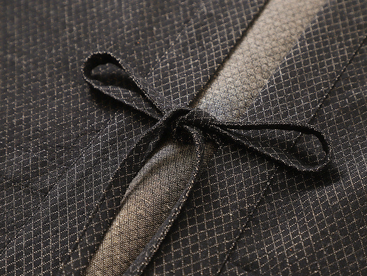 Close-up of the Karo haori jacket's waist tie knotted in a bow against the fine diamond weave