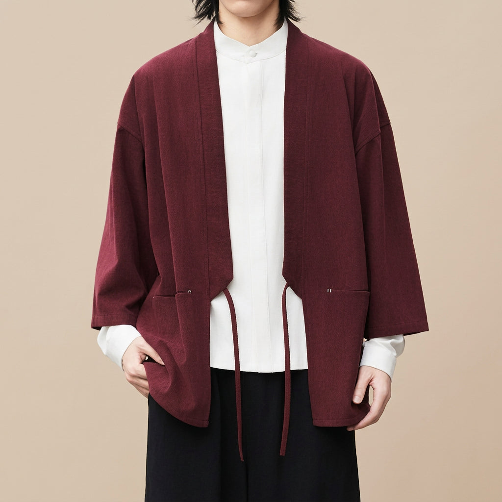Nagi haori cardigan in wine red, worn open on the street with a hand in the hip pocket, three-quarter sleeves over a white shirt