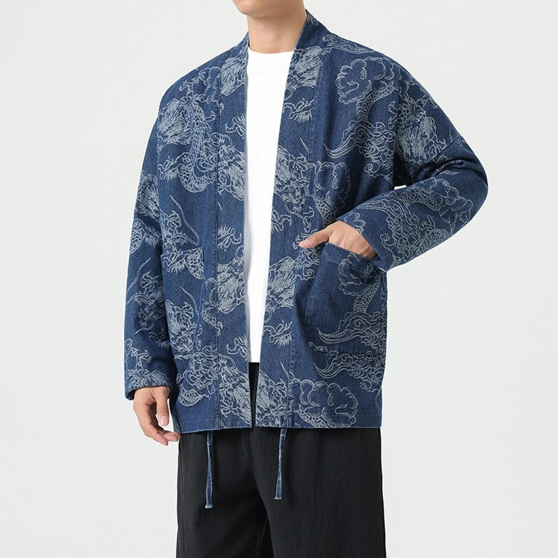 Unryu denim haori in indigo, worn open with a hand in the hip patch pocket, cloud-dragon print at higher contrast