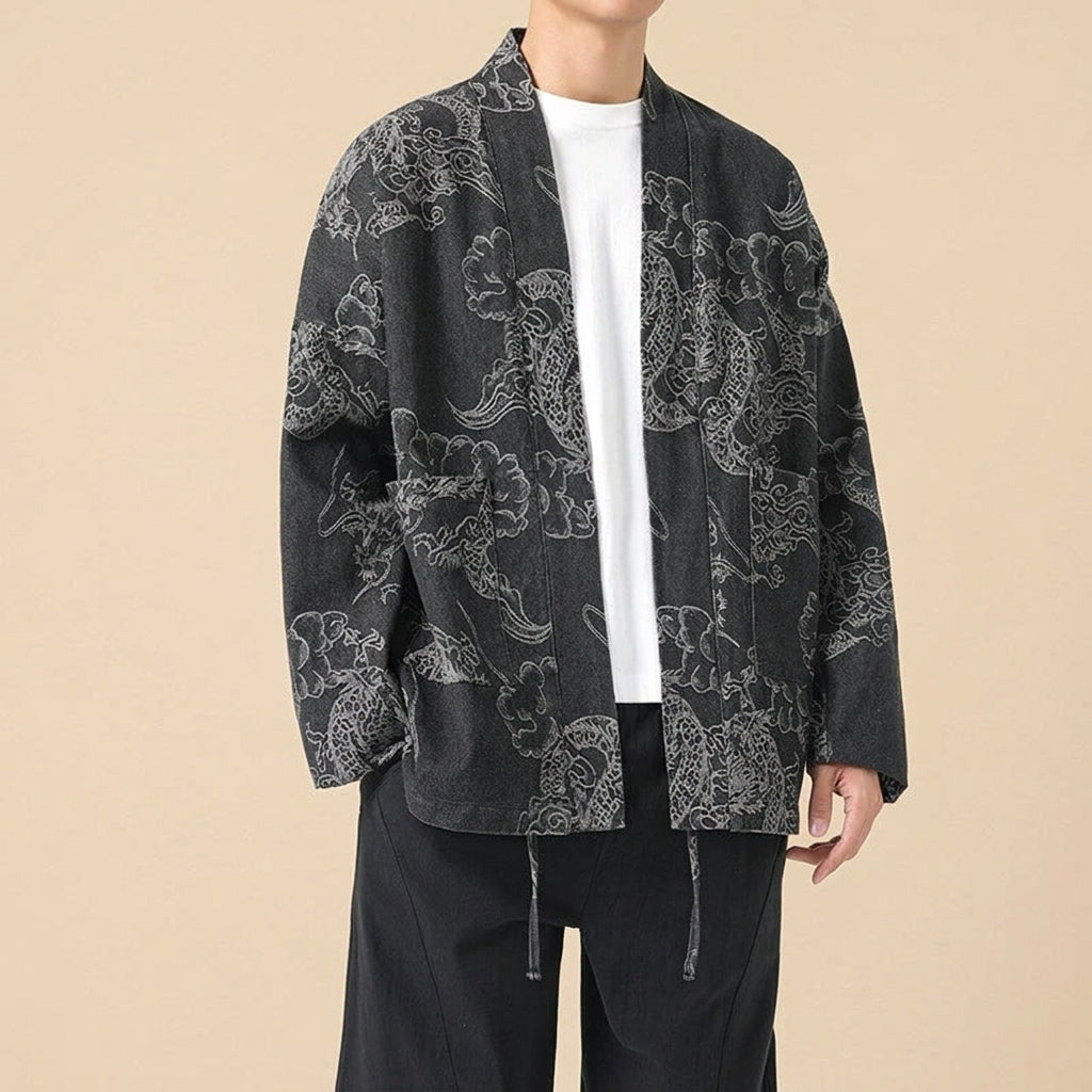 Unryu denim haori in washed black, worn open over a white t-shirt, showing the pale cloud-dragon print and hanging waist ties